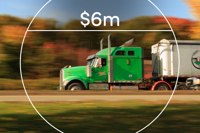 Tractor-trailer on the highway with text overlaid: $6m