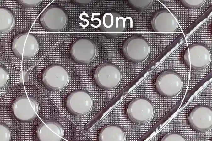 White pills in a blister pack with a $50m label overlaid in the center.